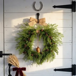 Rustic Christmas pine needle wreath with pine cones, burlap bow and golden bell