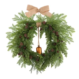 Christmas cedar wreath with rustic pine cones, burlap bow and vintage metal bell.