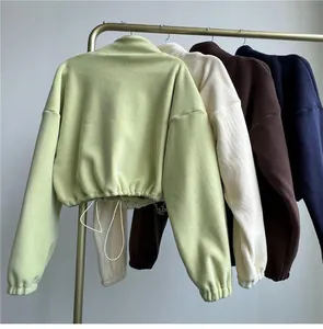 Detailed view of cropped fleece sweatshirts with drawstring hem in multiple colors