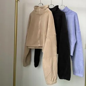Detailed view of women's warm fleece zip-up jackets in beige, black and purple