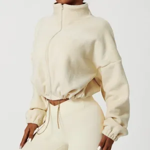 Close-up detail of cream fleece cropped zip-up sports jacket featuring adjustable drawstring