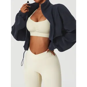 Stylish navy thick fleece zip-up jacket paired with cream sports bra and leggings fitness set