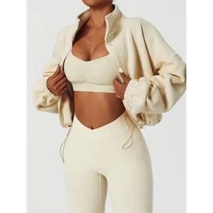 Women's cream fleece sports jacket with matching sports bra and leggings