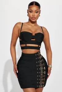 Stunning detail of a black bandage crop top and buckle mini skirt two-piece set on a model