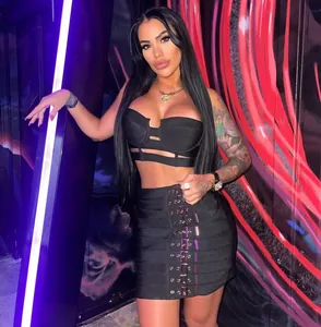 Detail showing the complete look of the sexy two-piece set with buckle mini skirt