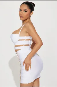 Professional side view of white bandage crop top and mini skirt set with buckles.