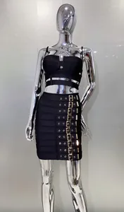Close-up detail of black two-piece bandage set featuring gold buckle mini skirt design