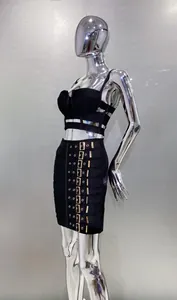 Close-up of black two-piece set featuring camisole top and buckle detail mini skirt