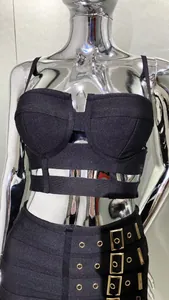 Close-up detail of a black two-piece fashion set with a cutout top and buckle mini skirt