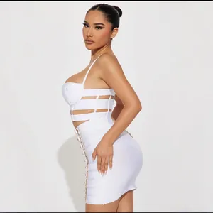 Sexy white two-piece set featuring a bandage cut-out crop top and buckled mini skirt