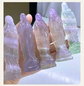 Detailed macro view of natural hand-carved fluorite crystal figurines in various macaron colors