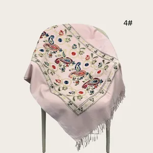 Detail view of pink pashmina shawl featuring intricate floral paisley embroidery and fringe
