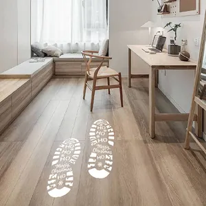 Autocollants de sol en forme d'empreintes de Père Noël blanc pour décoration de Noël.