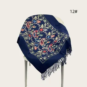 Detailed view of elegant navy blue embroidered shawl with floral patterns and fringe