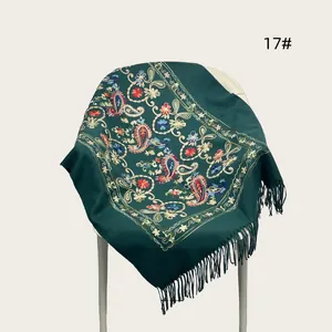 Detailed dark green shawl featuring elegant paisley embroidery and delicate fringes.