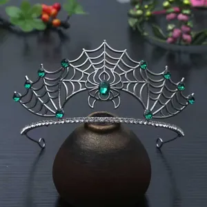 Detailansicht der silbernen gotischen Spinnennetz-Tiara mit smaragdgrünen Edelsteinen für Halloween