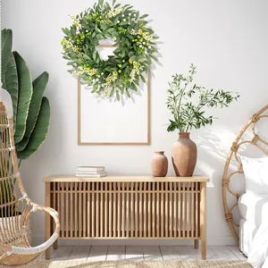 Realistic artificial eucalyptus berry wreath hanging as wall decor in a modern room