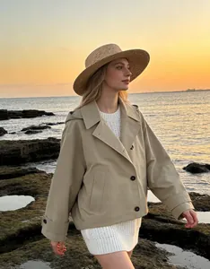 Stylish khaki hooded poncho trench coat jacket shown on model at sunset beach