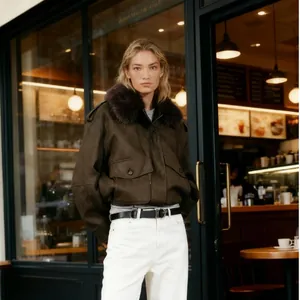 Close-up of a stylish brown suede jacket with a plush faux fur collar on a model