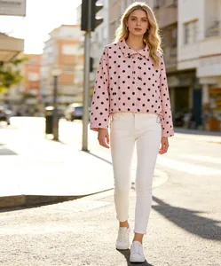 Stylish pink polka dot drawstring jacket for women showcased on a sunny outdoor street