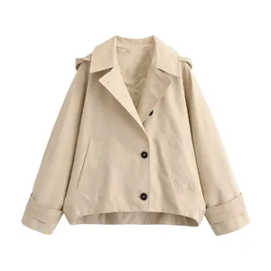 Detailed view of a stylish beige hooded cape windbreaker jacket featuring dark buttons.