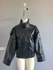 Full detail shot of an oversized black faux leather moto jacket with a double collar