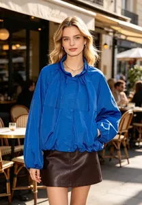 Electric blue women's stand collar pleated nylon jacket in a stylish outdoor setting
