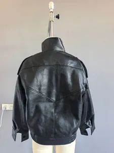Detailed back view of a black pebbled faux leather oversized jacket with V-shaped stitching