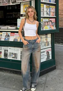 Vintage-inspired wide-leg denim jeans with unique flipped-waist detail and washed finish.