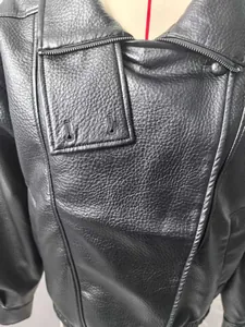 Close-up detail of black faux leather jacket with textured grain and premium stitching