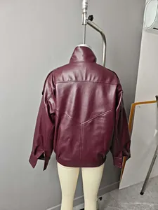 Back view of a burgundy oversized faux leather jacket on a mannequin showing texture