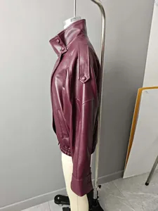 Side profile of a stylish burgundy oversized faux leather bomber jacket for women