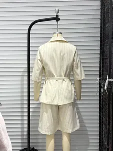 Back view of a chic pinstriped two-piece set featuring a belted blazer and shorts