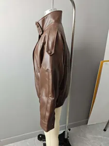 Side profile of an oversized brown faux leather jacket for women with a high collar