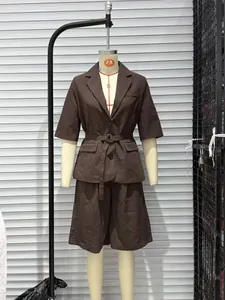 Detail of a professional brown two-piece suit set with belted blazer and shorts.