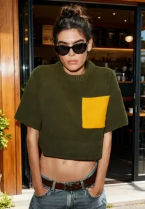 Stylish olive green short-sleeved knit sweater featuring a vibrant yellow pocket detail.