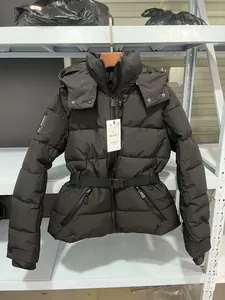 Detailed view of black waist-cinching puffer jacket with hood and belt on a rack
