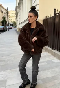 Stylish dark brown faux fur jacket for women, chic winter fashion streetwear outfit.
