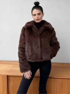 Elegant woman wearing a stylish brown faux fur short jacket with a lapel collar for winter