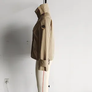 Side view of a khaki retro short trench coat featuring lapel and shoulder epaulettes