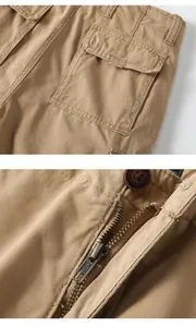 Close-up detail of vintage khaki cargo shorts showing the YKK zipper and stitching
