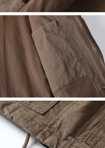 Detailed view of internal pocket and heavy cotton fabric of a brown casual jacket.