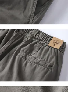Detailed view of the elastic waistband and rear pocket on these olive green cargo shorts