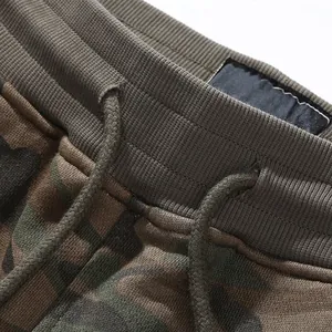 Detailed view of American vintage camouflage joggers with elastic drawstring waist and cotton fabric