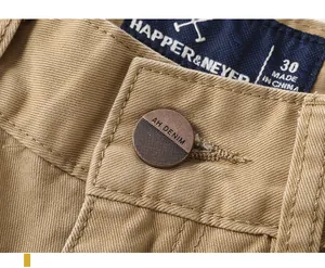 Macro shot of button and label detail on men's vintage khaki cotton cargo pants