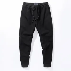 Men's solid black cotton joggers with elastic drawstring waist and ribbed cuffs