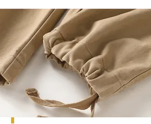 Detailed macro view of the elasticated drawstring cuff on vintage khaki cotton cargo pants
