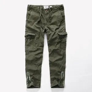 Vintage olive green washed cotton cargo pants with drawstring waist and leg zip detail