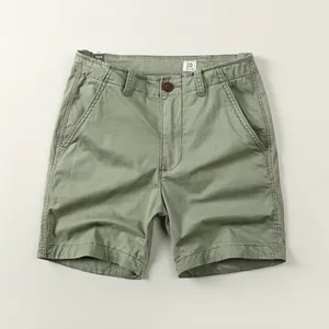Vintage-style men's olive green casual cotton shorts with relaxed fit and button fly.