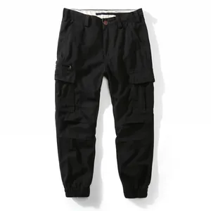 Professional studio shot of loose-fit black men's cargo jogger pants with utility pockets
